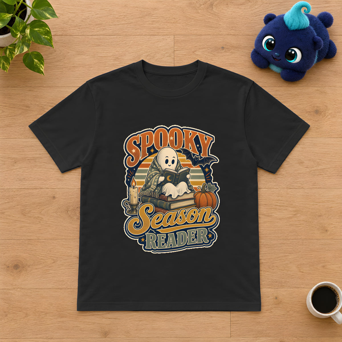 Spooky Season Reader T-Shirt, Cozy Fall Gift for Book Lovers – Black t-shirt styled with Plip